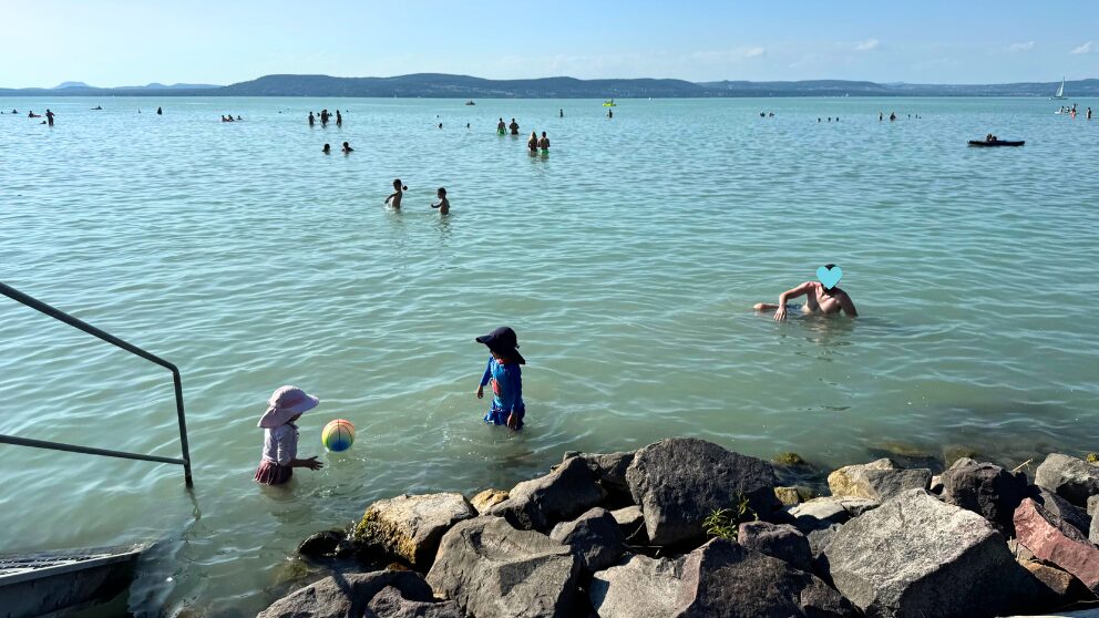 ハンガリーのバラトン湖畔の町、Balatonnlelleの無料ビーチで遊ぶ夫と子供たち