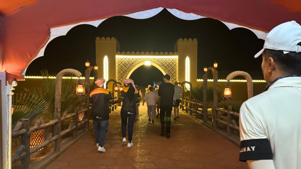 アブダビの砂漠ツアーのデザートキャンプを後に、車へ戻っていく人々