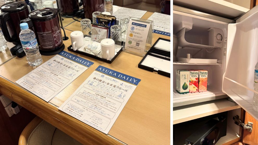 飛鳥Ⅱ客室のデスク。左側には船内新聞「ASUKA DAILY」が2枚、電気ケトル、お茶セット、ミネラルウォーターが並ぶ。右側の開いた冷蔵庫には、生茶とトロピカーナのジュース、ミネラルウォーターが入っている