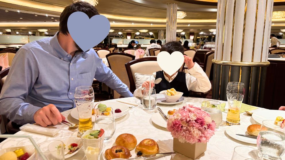 華やかな照明のメインダイニング「フォーシーズン」で、夕食を楽しむ夫と息子