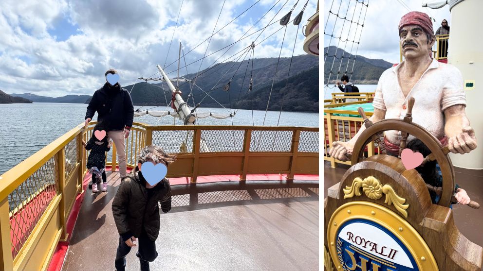 芦ノ湖の海賊船のデッキで遊ぶ子どもと家族、湖と山の景色