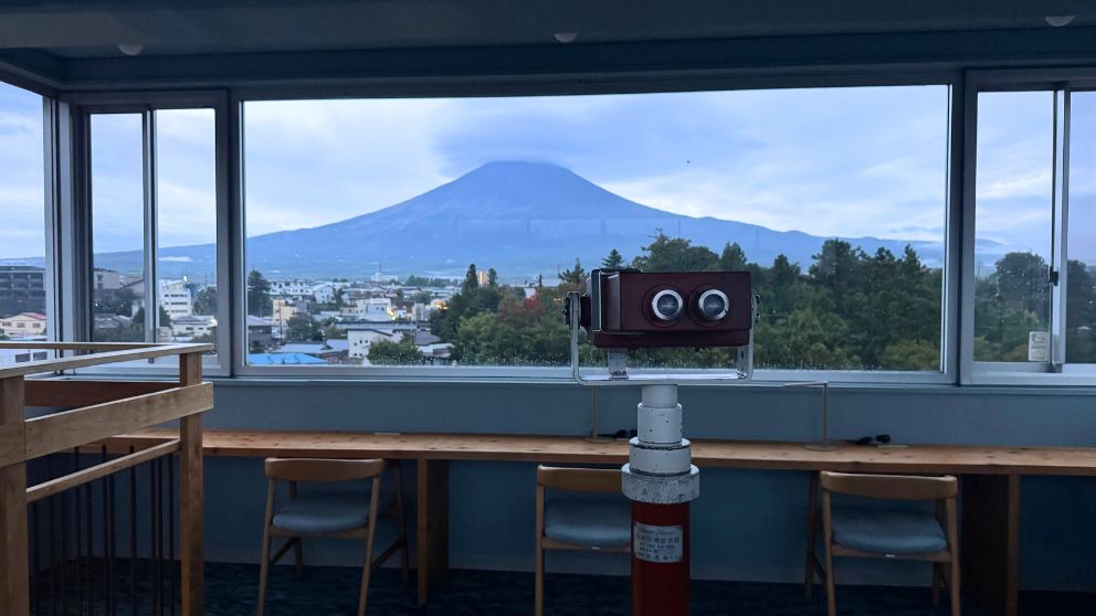 富士レークホテルの展望台からみた富士山。室内の展望台でテーブルの前には椅子が並んでいる