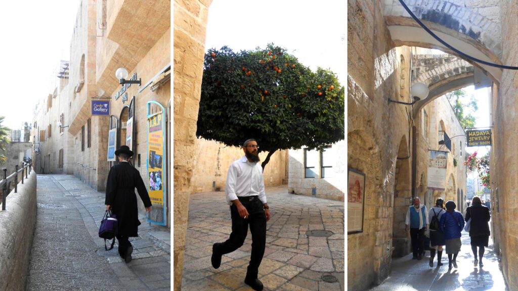 エルサレムのユダヤ人地区の路地。黒い服のユダヤ教徒、オレンジの木の下を歩く男性、アーケードの通りと多様な日常の光景