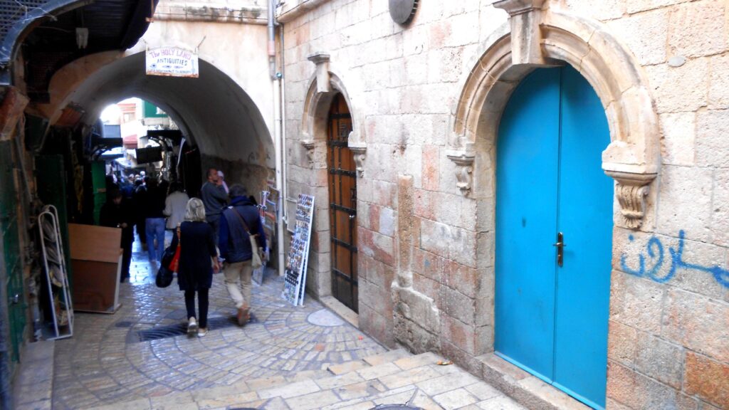 悲しみの道・ベロニカの場所付近の路地。青いドアと石造りの建物が続くエルサレム旧市街の小道