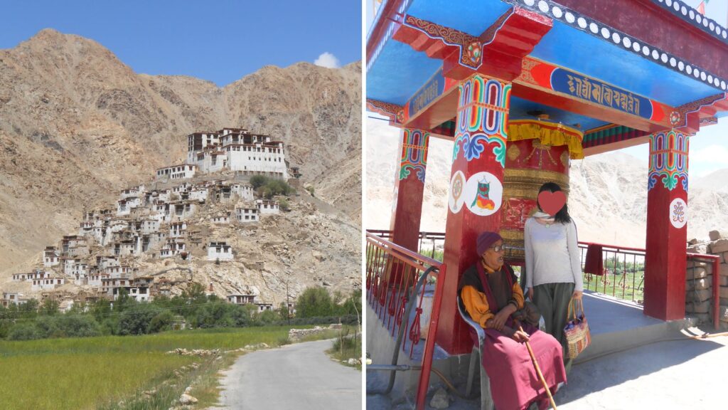 ラダックの岩山に建つゴンパと、色鮮やかなマニ車の東屋でくつろぐ地元の男性