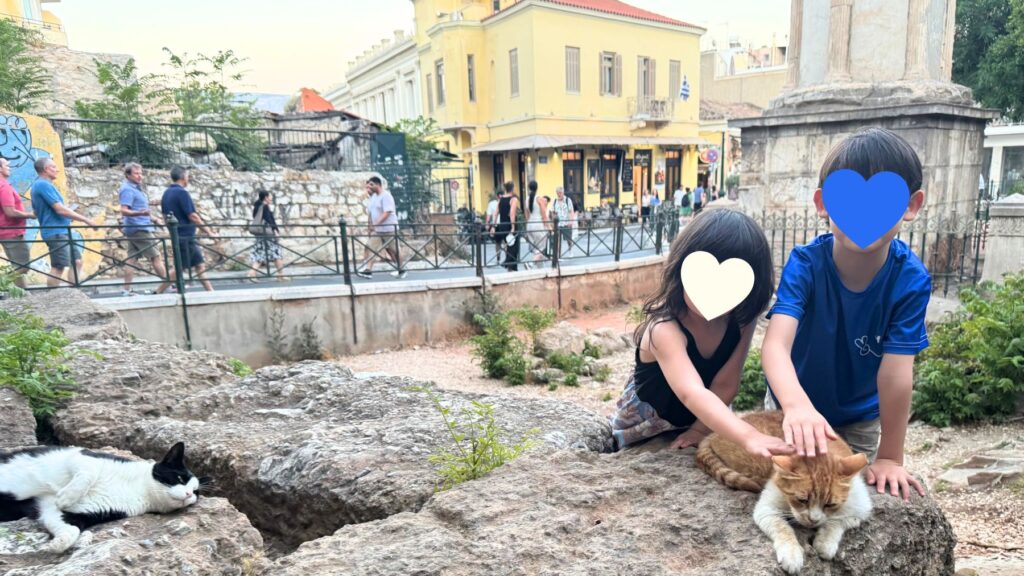 プラカ地区の遺跡そばで猫をなでる子どもたち