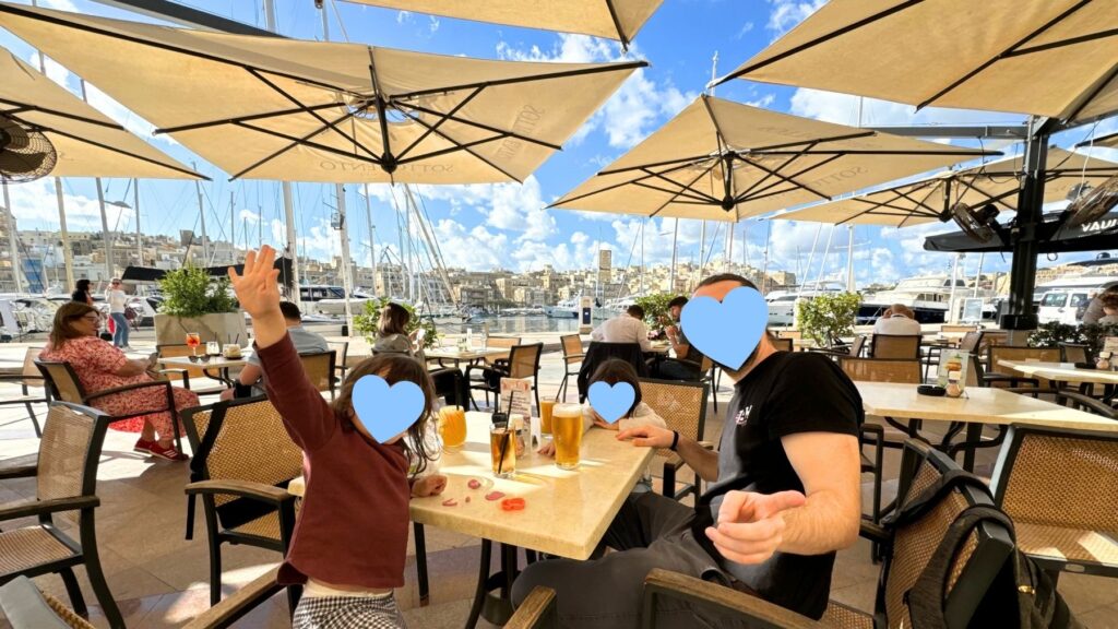 ビルグのヨットハーバー沿いのカフェのテラス席でひと休みする家族。